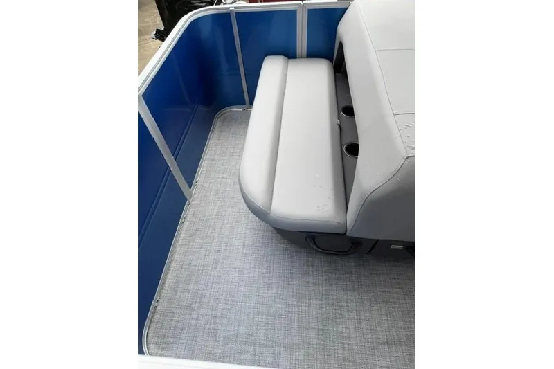 Slide: The Image of 2026 Sun Tracker Party Barge 18 DLX interior with gray seating and blue paneling. - 13