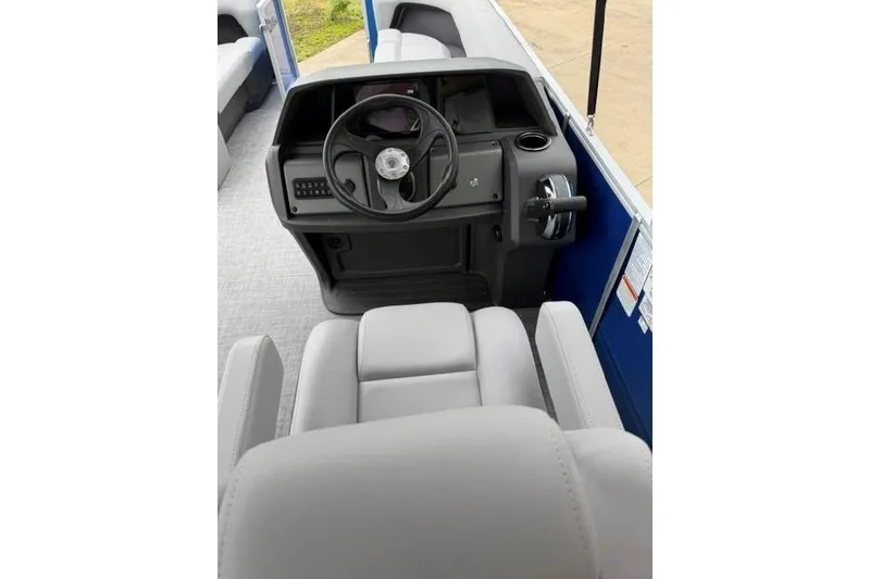 Slide: The Image of 2026 Sun Tracker Party Barge 18 DLX helm with steering wheel and controls. - 5