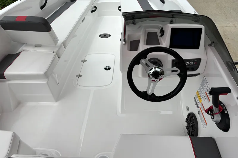 Slide: The Image of Interior view of 2026 Tahoe T18 boat, featuring steering wheel and seating area. - 5
