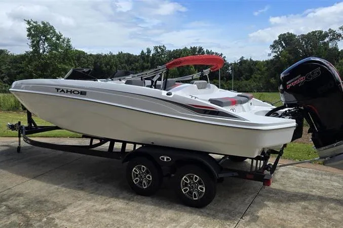 Slide: The Image of 2026 Tahoe T21 boat on trailer, featuring sleek design and powerful engine, parked outdoors. - 5