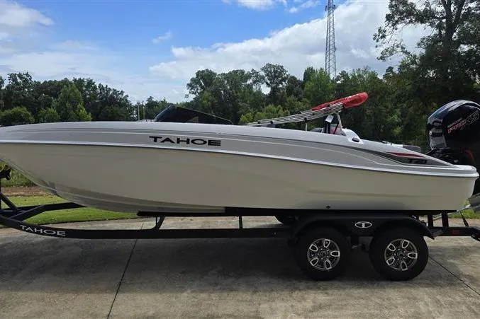 Slide: The Image of 2026 Tahoe T21 boat on trailer, sleek design, parked outdoors. - 4