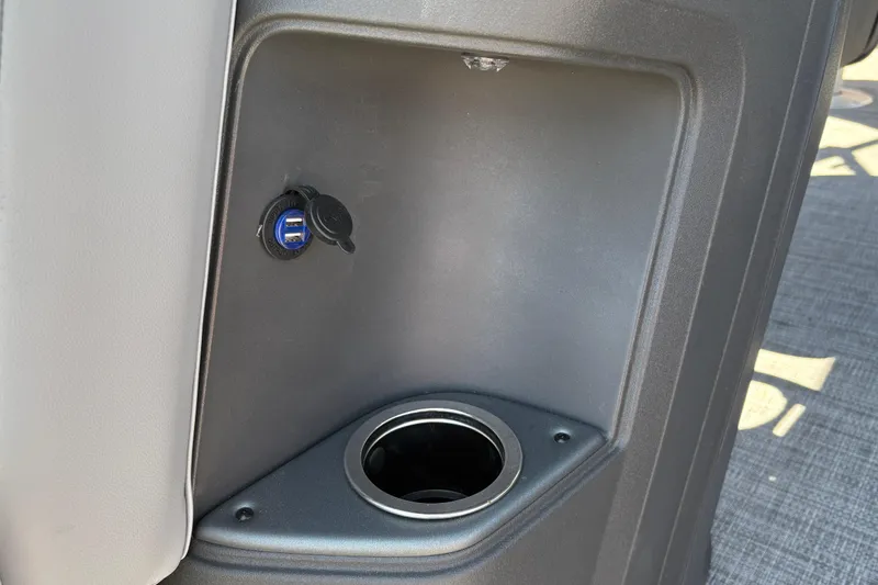 Slide: The Image of 2026 Sun Tracker SportFish 20 DLX boat console with USB port and cup holder. - 24