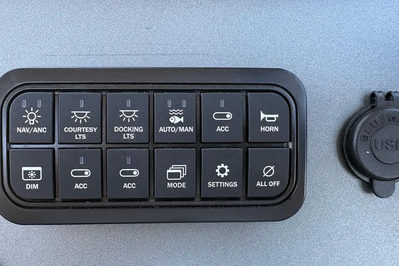 Slide: The Image of Control panel of 2026 Sun Tracker SportFish 20 DLX with various function buttons. - 19