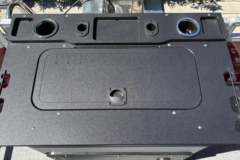 Slide: The Image of 2026 Sun Tracker SportFish 20 DLX boat console with cup holders and storage compartments. - 27