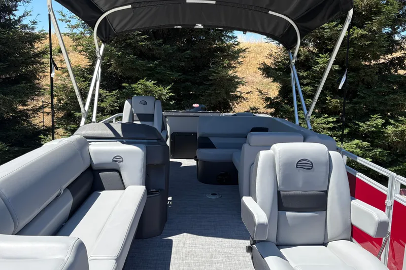 Slide: The Image of 2026 Sun Tracker SportFish 20 DLX pontoon boat interior with gray seating and canopy. - 33