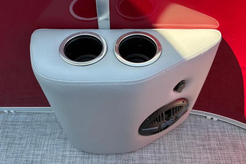 Slide: The Image of Cup holders and speaker on 2026 Sun Tracker SportFish 20 DLX boat interior. - 31