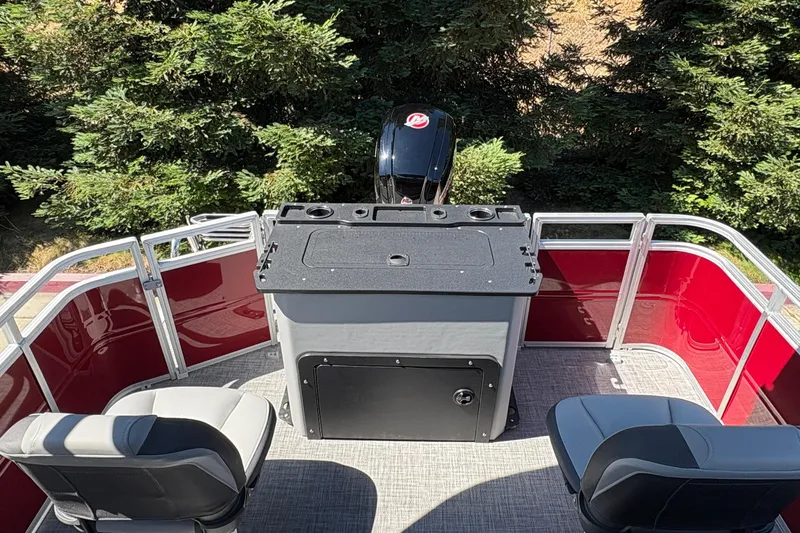 Slide: The Image of 2026 Sun Tracker SportFish 20 DLX pontoon boat interior with seating and control panel. - 32