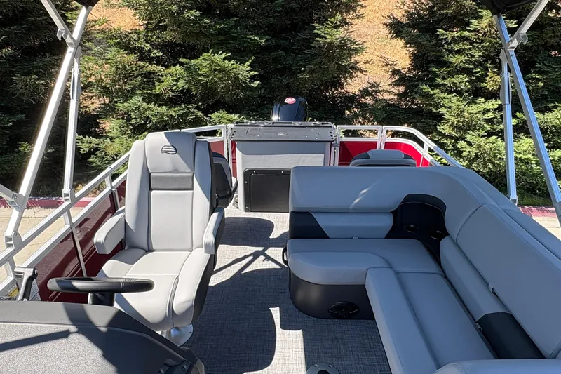 Slide: The Image of 2026 Sun Tracker SportFish 20 DLX pontoon boat interior with seating and helm. - 35