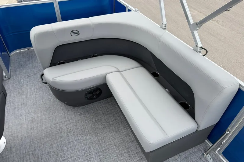 Slide: The Image of 2026 Sun Tracker Party Barge 18 DLX interior seating with gray upholstery and cup holders. - 19