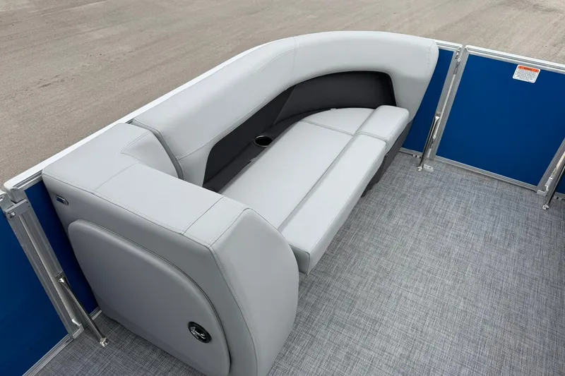 Slide: The Image of 2026 Sun Tracker Party Barge 18 DLX interior with gray seating and blue paneling. - 12