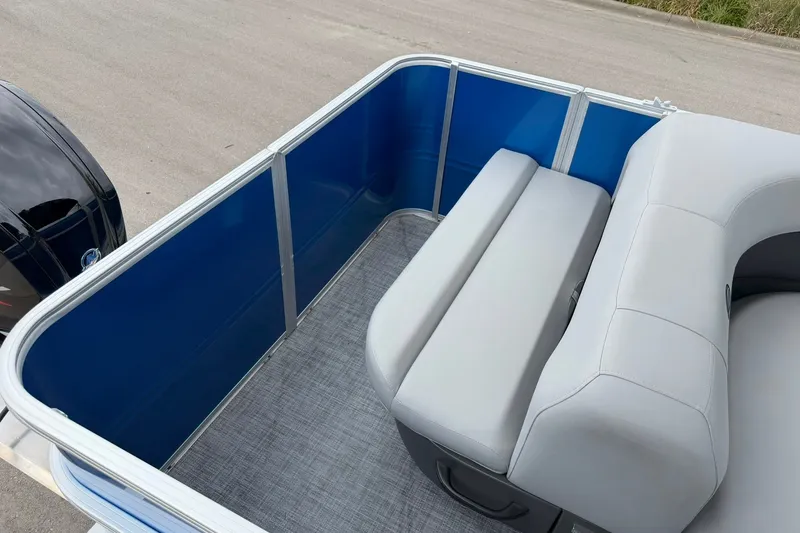 Slide: The Image of 2026 Sun Tracker Party Barge 18 DLX interior with blue panels and gray seating. - 21
