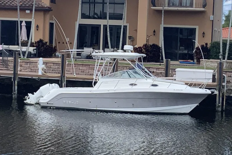 The Image of 2007 Robalo R305 Walkaround boat docked by waterfront home. - 0