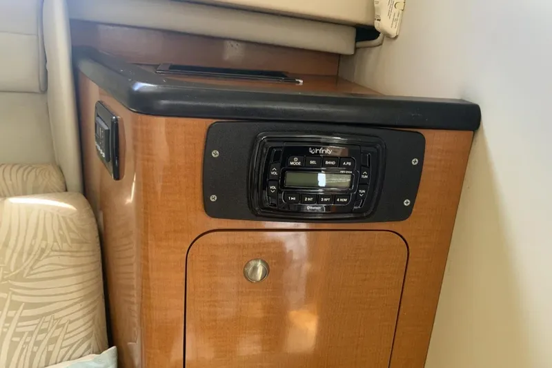 Slide: The Image of 2007 Robalo R305 Walkaround cabin interior with wood finish and Infinity stereo system. - 13