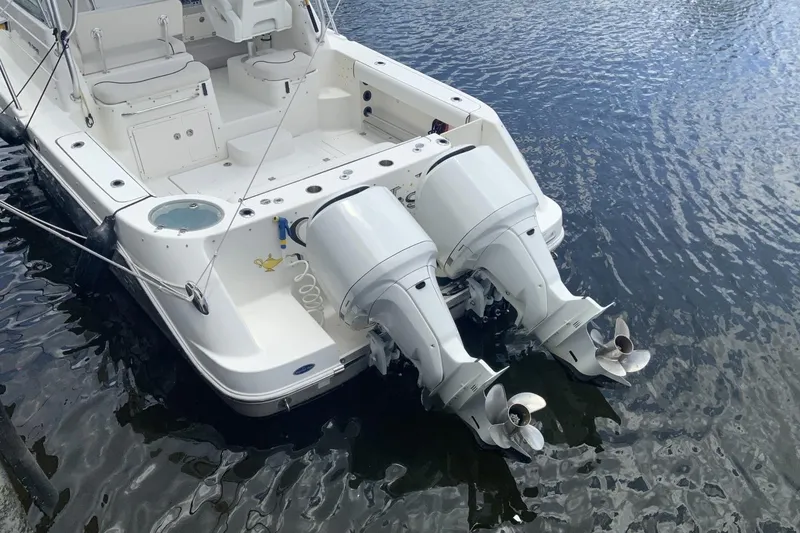 Slide: The Image of 2007 Robalo R305 Walkaround boat with dual outboard motors on water. - 15