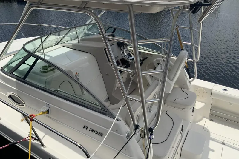 Slide: The Image of 2007 Robalo R305 Walkaround boat with sleek design and spacious cockpit. - 2