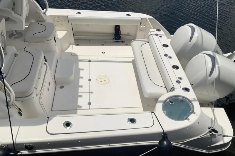 Slide: The Image of 2007 Robalo R305 Walkaround boat deck with seating and twin outboard engines. - 3