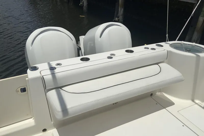 Slide: The Image of 2007 Robalo R305 Walkaround boat with dual engines and cushioned seating. - 4