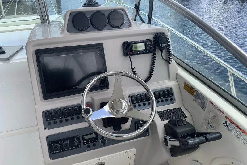 Slide: The Image of 2007 Robalo R305 Walkaround helm with steering wheel, controls, and navigation equipment. - 8