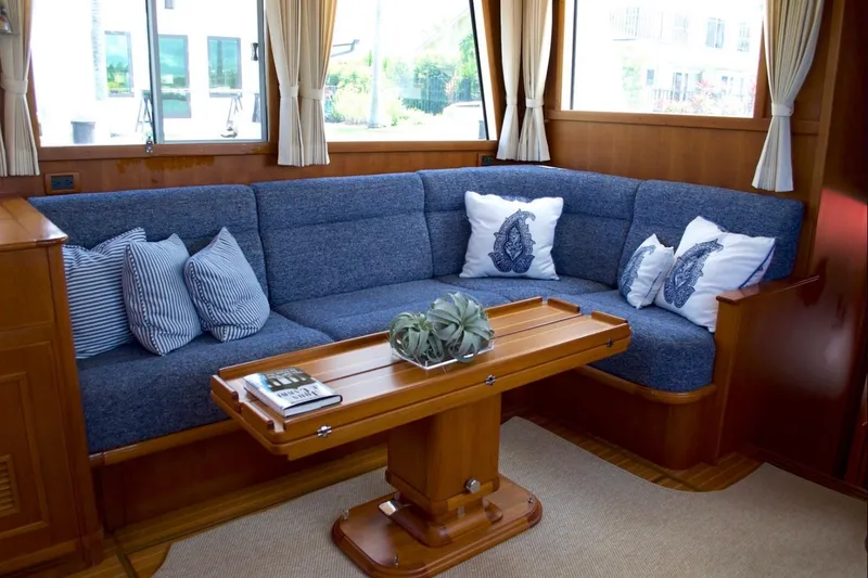 Slide: The Image of Luxurious 2009 Grand Banks 47 Heritage CL yacht interior with blue sofa and decorative pillows. - 10