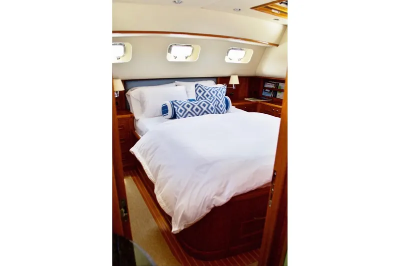 Slide: The Image of Luxurious bedroom interior of 2009 Grand Banks 47 Heritage CL yacht, featuring elegant bedding. - 11