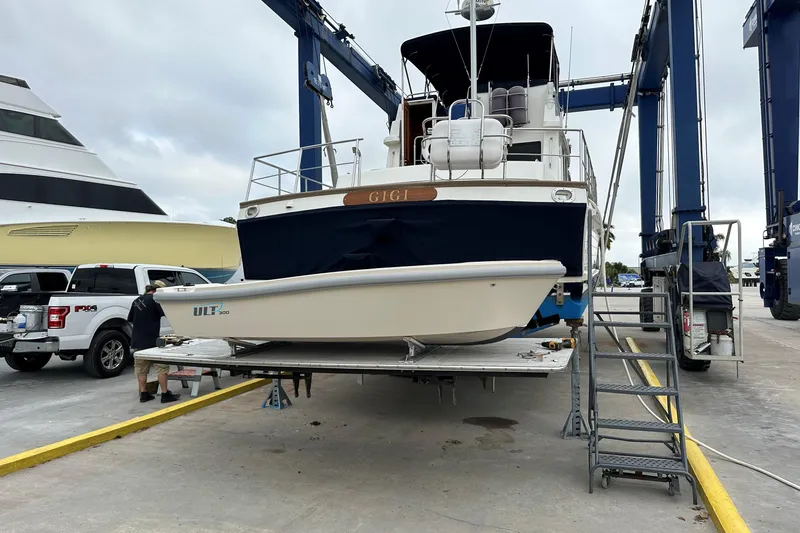 Slide: The Image of 2009 Grand Banks 47 Heritage CL yacht on lift with smaller boat beneath. - 14