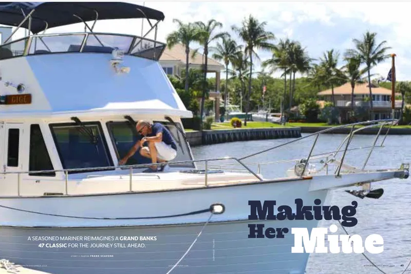 Slide: The Image of A person on a 2009 Grand Banks 47 Heritage CL yacht by a waterfront. - 18
