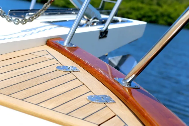 Slide: The Image of Close-up of 2009 Grand Banks 47 Heritage CL yacht deck with polished wood and metal details. - 2