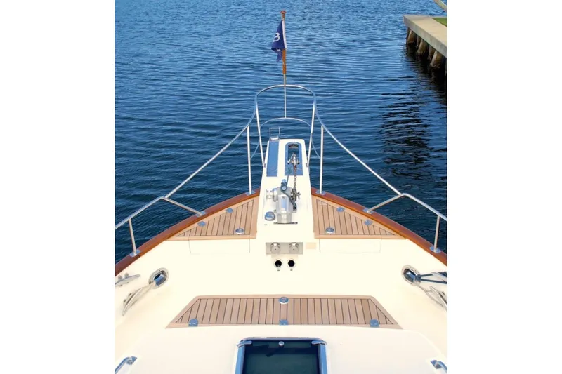 Slide: The Image of Bow view of 2009 Grand Banks 47 Heritage CL yacht on calm water. - 5