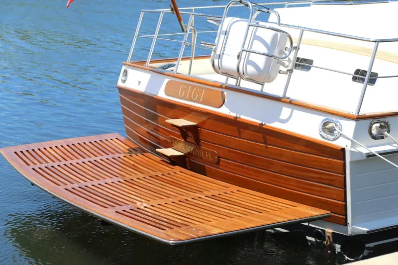 Slide: The Image of 2009 Grand Banks 47 Heritage CL yacht with wooden swim platform on calm water. - 7
