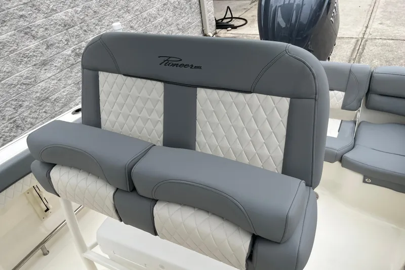 Slide: The Image of 2026 Pioneer 202 Islander boat with luxurious gray and white quilted seating. - 10