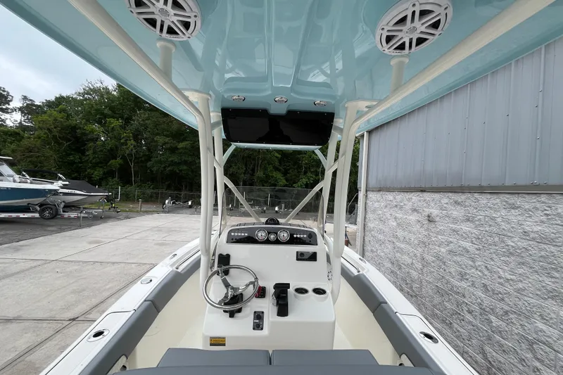 Slide: The Image of 2026 Pioneer 202 Islander boat interior with steering wheel, dashboard, and overhead speakers. - 12