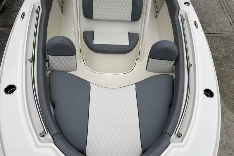 Slide: The Image of 2026 Pioneer 202 Islander boat interior with gray and white cushioned seating. - 18