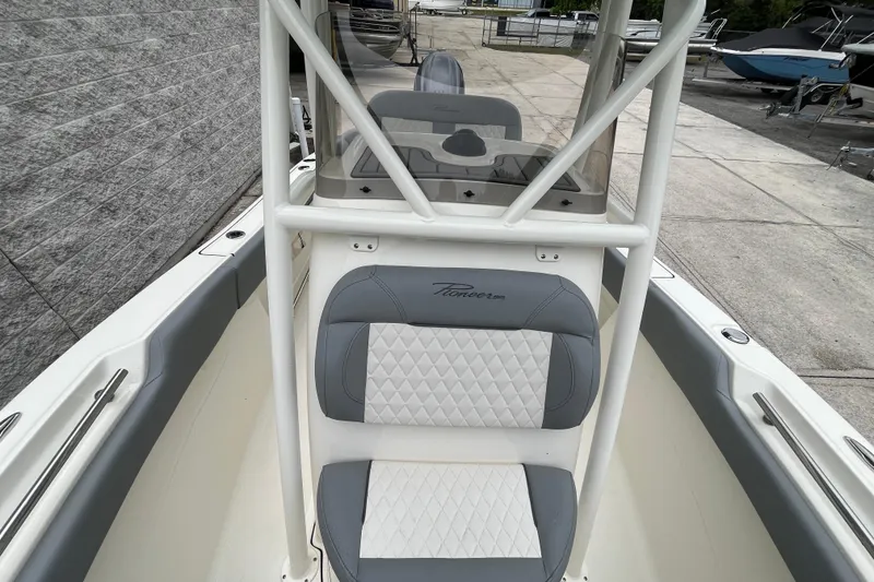 Slide: The Image of 2026 Pioneer 202 Islander boat interior with cushioned seating and sleek design. - 22