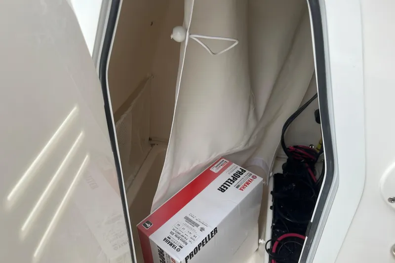 Slide: The Image of Storage compartment of 2026 Pioneer 202 Islander boat with Yamaha propeller box. - 24