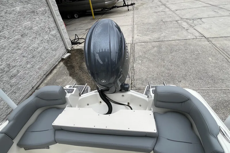 Slide: The Image of 2026 Pioneer 202 Islander boat with sleek seating and powerful outboard motor. - 27