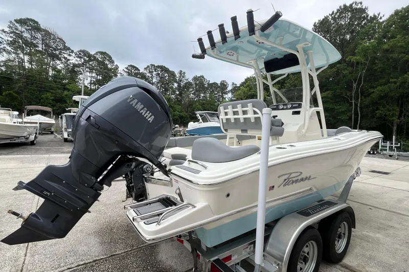Slide: The Image of 2026 Pioneer 202 Islander boat with Yamaha engine on trailer, parked outdoors. - 3
