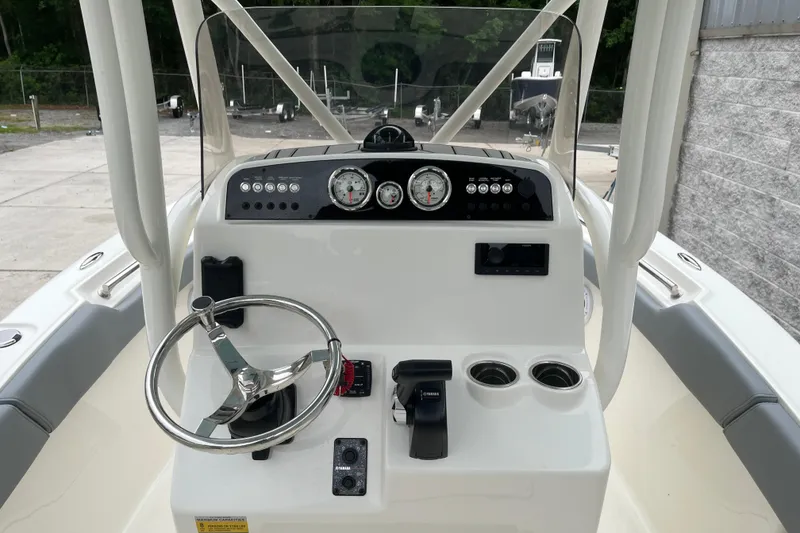 Slide: The Image of 2026 Pioneer 202 Islander boat dashboard with steering wheel and controls. - 7
