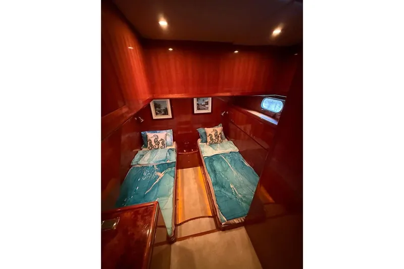 Slide: The Image of Luxurious twin cabin with teal bedding in 2008 Hampton 60' Aft Cabin Motor Yacht. - 12