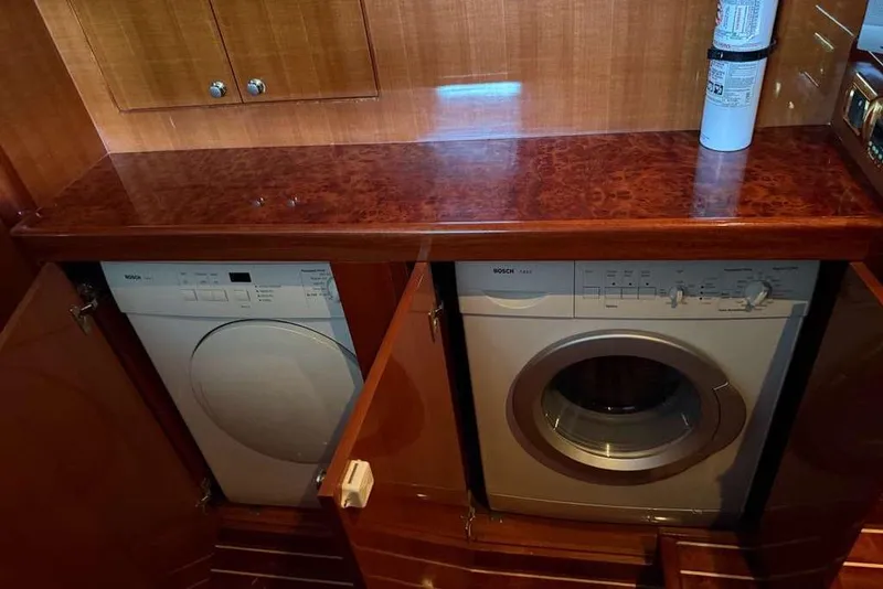 Slide: The Image of Laundry area with Bosch appliances on 2008 Hampton 60' Aft Cabin Motor Yacht. - 14