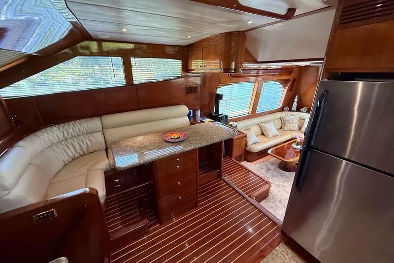 Slide: The Image of Luxurious interior of 2008 Hampton 60' Aft Cabin Motor Yacht with elegant seating and modern kitchen. - 5