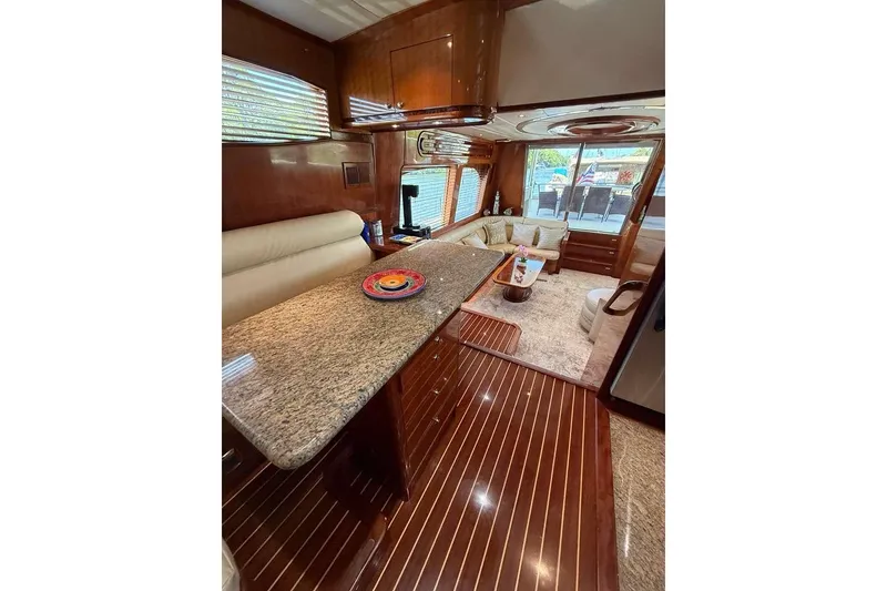 Slide: The Image of Luxurious interior of 2008 Hampton 60' Aft Cabin Motor Yacht with elegant wood finishes. - 8
