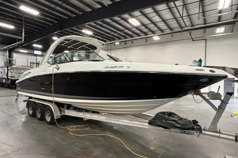 The Image of 2008 Sea Ray 300 Select EX boat on trailer in indoor storage facility. - 0