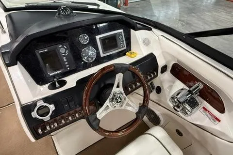 Slide: The Image of 2008 Sea Ray 300 Select EX dashboard with steering wheel and navigation controls. - 3