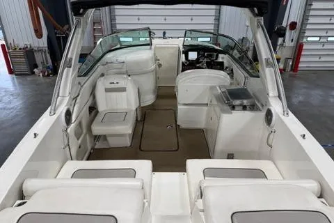 Slide: The Image of 2008 Sea Ray 300 Select EX boat interior with seating and helm in a garage setting. - 5