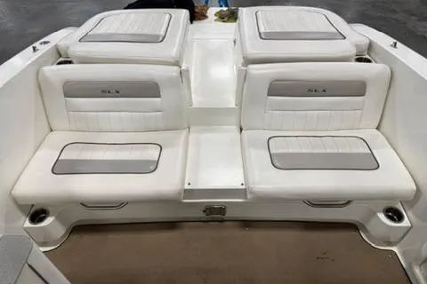 Slide: The Image of 2008 Sea Ray 300 Select EX boat interior with white cushioned seating. - 6
