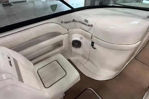Slide: The Image of 2008 Sea Ray 300 Select EX boat interior with white seating and speaker. - 8
