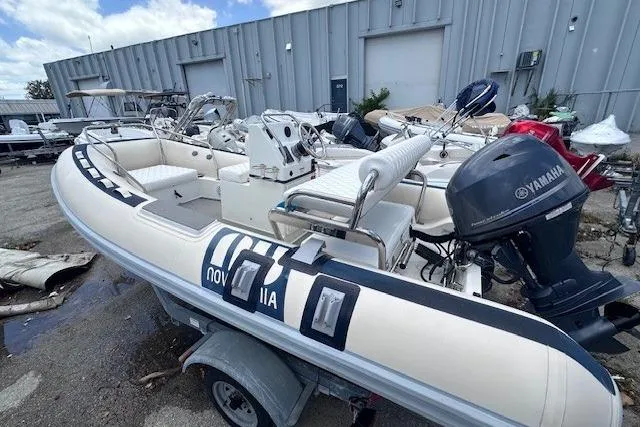 Slide: The Image of 2015 Novurania DL 460 inflatable boat with Yamaha outboard motor, parked outdoors. - 10