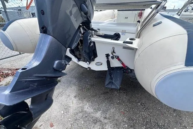 Slide: The Image of 2015 Novurania DL 460 boat with outboard motor, parked on gravel surface. - 11