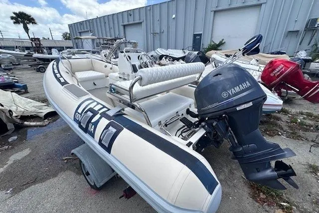 Slide: The Image of Novurania DL 460 boat, 2015 model, with Yamaha outboard motor, parked outdoors. - 6