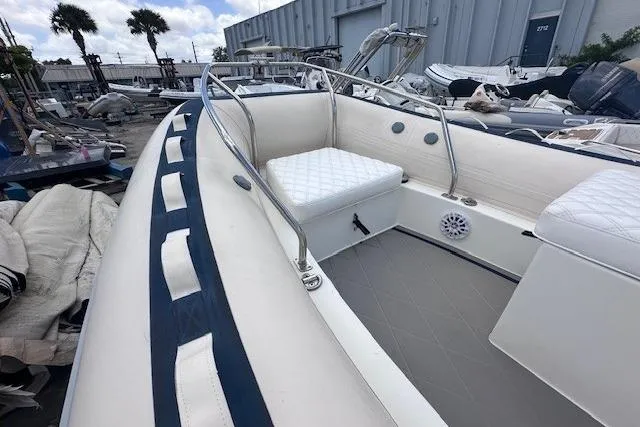 Slide: The Image of 2015 Novurania DL 460 inflatable boat with cushioned seating, docked outdoors. - 9